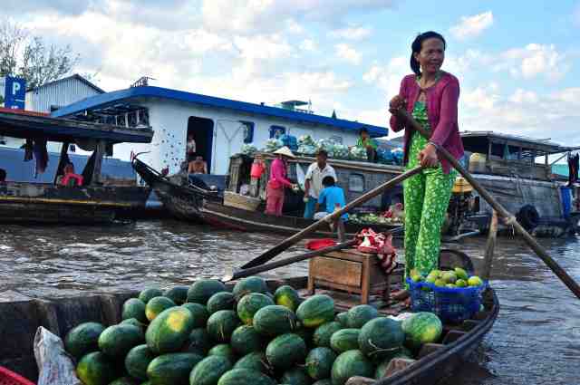 Woman picking up her mellons - Mekong Delta, Vietnam